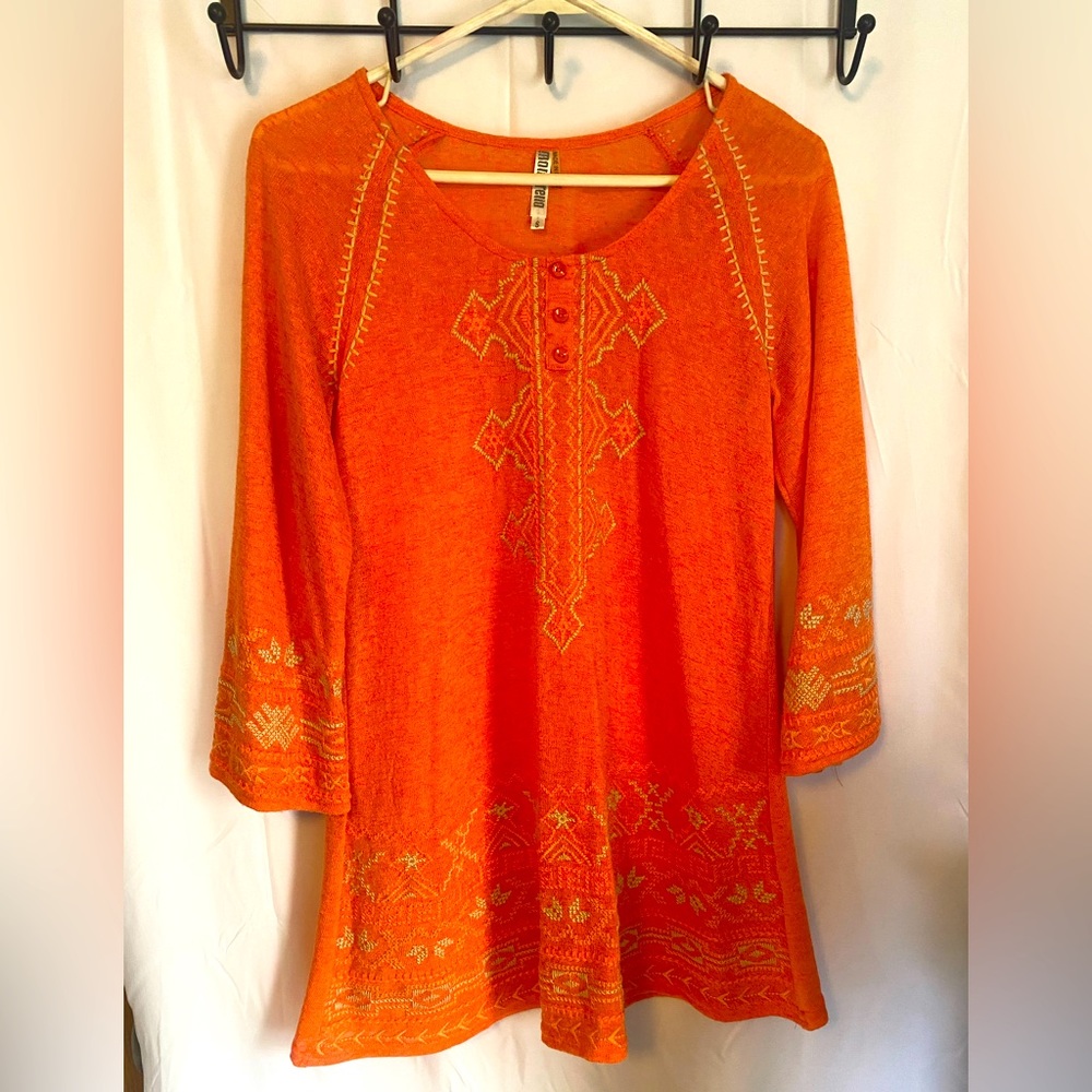 Orange blouse with slight flare at bottom